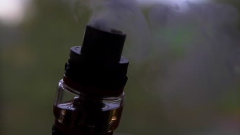 A-close-shot-of-the-tank-of-a-vaporizer-while-it-smokes-in-slow-motion