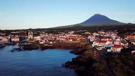 Aerial-landscape-shot-of-Madalena-town-and-the-coast-in-Pico-Island-at-sunset