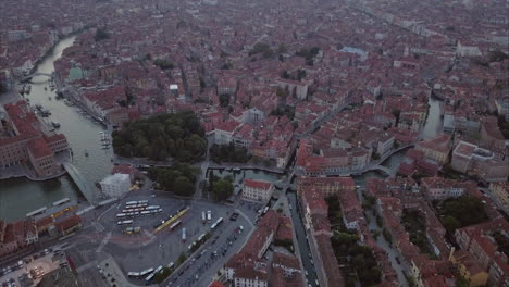 Wide-aerial-shot-revealing-Santa-Croce-area-from-above-at-dusk,-Venice,-Italy