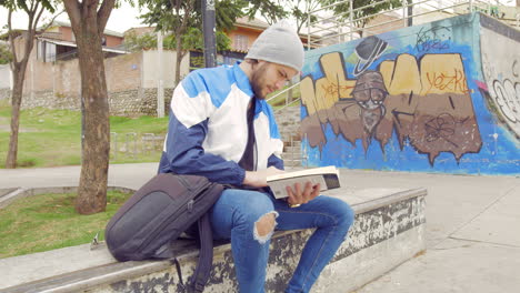 Young-boy-reading-a-book-on-the-street