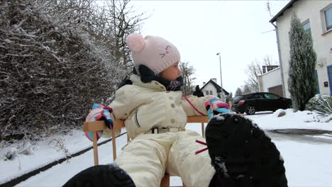 A-little-girl-is-on-a-snow-sleigh