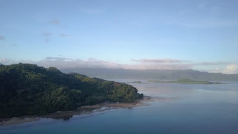 Aerial-tracking-view-of-tropical-green-island-at-daybreak-in-Asia