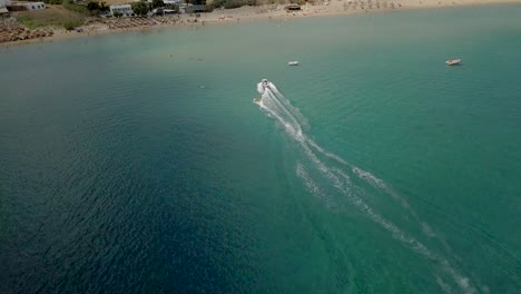 A-speedboat-approaches-Golden-Beach-after-pulling-a-passenger-on-a-tube