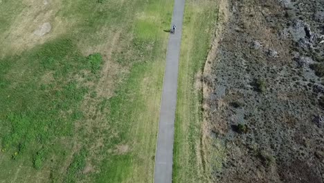 Aerial-shot,-tracking-on-a-person-cycling-on-the-bike-track-in-napier,-new-zealand