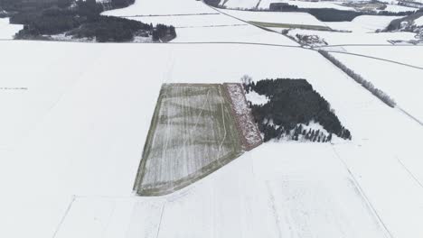 Drohnenaufnahme-Eines-Kleinen-Hektars-In-Einer-Verschneiten-Landschaft