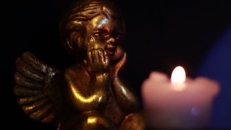 Angel-Figurine-Looking-At-The-Candle