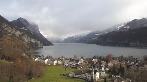 Beautiful-fjord-with-a-small-village-on-the-shore-in-Switzerland-while-winter