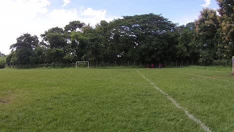 View-of-a-group-of-young-women-in-the-middle-of-a-soccer-training,-recorded-from-a-drone