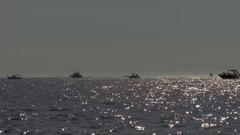 Slow-motion-gimbaled-shot-of-a-group-of-boats-fishing-in-the-Sea-of-Cortez-during-late-afternoon