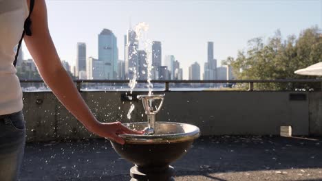 Drinking-fountain-with-Brisbane-CBD-in-background,-Australia