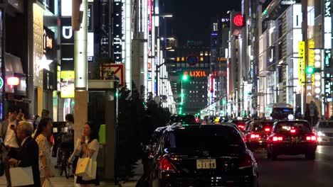 The-view-of-the-famous-shopping-street-Ginza-,-cars-and-walking-people-at-night