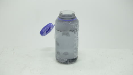 Dry-ice-cube-bubbling-in-a-bottle