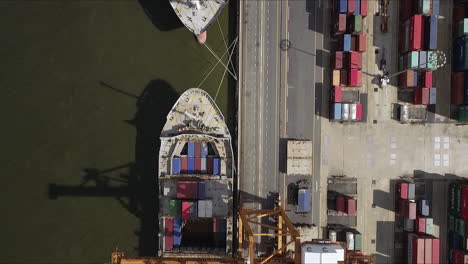 Logistic-concept-aerial-View-of-maritime-transport-commercial-dockyard-with-cargo-ships,-containers-waiting-to-be-Upload-and-Offload-Cargo-Containers