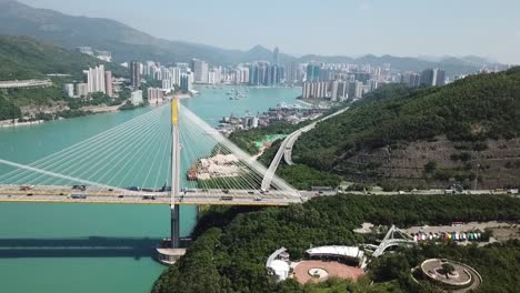 Aerial-shot,-track-on-Ting-Kau-Bridge-rotating-angles-of-view-looking-though-bridge-and-both-buildings-and-mountain-in-the-background