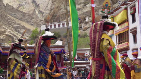 Mid-shot-of-monks-wearing-colorful-dresses-and-hats-dancing-at-Hemis-festival-in-monastery
