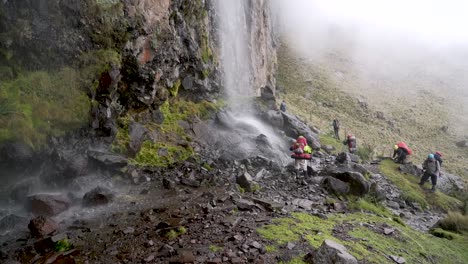 People-walking-near-a-waterfall-in-the-beautiful-iztaccihuatl-volcano-in-Mexico-in-a-trek-at-about-4,400-meters-above-sea-level