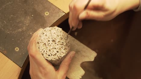 Making-holes-in-concrete-cylinder-with-rounded-file---detail-shot