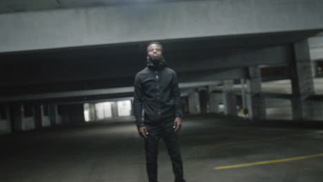 Zoom-into-an-African-American-man-standing-still-in-a-parking-garage