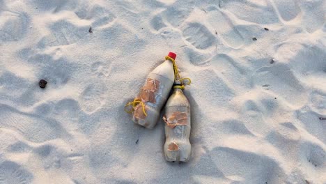 Coca-Cola-Coke-Plastic-Bottles-Lying-In-The-Sand