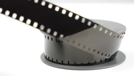 Old-8mm-vintage-film-on-white-table,-focus-pull