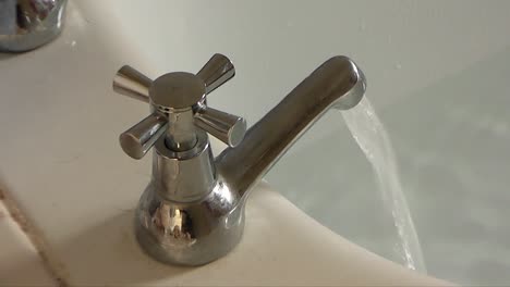 A-tap-runs-hot-water-into-a-half-full-bath