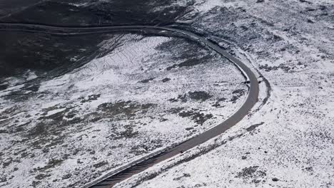 AERIALS-of-Snowy-landscape-in-Lesotho,-Africa---Snow-fall-in-Africa-Car-driving-on-roads-in-snowy-landscape