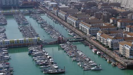Aerial-view-of-moored-sailing-boats---yachts-in-Brighton-Marina,-on-the-Southern-coast-of-the-UK