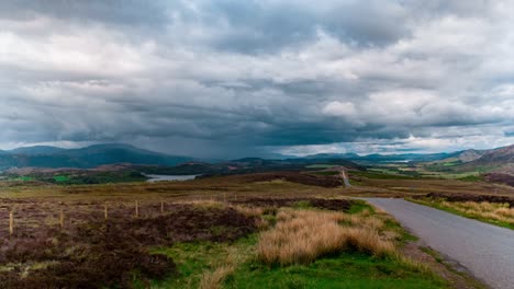 Cinematic-timelapse-of-scottish-road-with-highland-fields-in-background