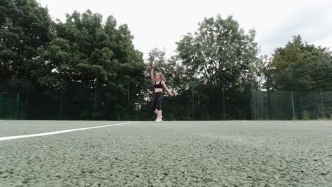Caucasian-female-amateur-tennis-player-performing-a-serve