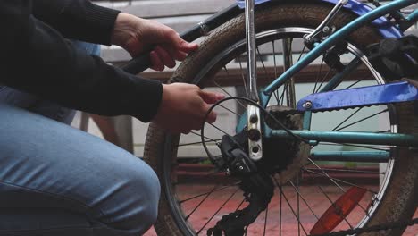 Man-inflating-the-flat-tire-of-the-bicycle