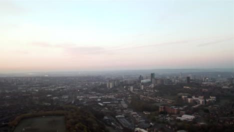 Aerial-Pan-Reveal-of-Leeds-Cityscape-at-Dawn-on-Sunny-Spring-Day