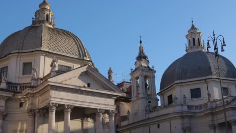 Tilt-down-shoot-for-The-twin-churches-in-people’s-square-in-Rome-with-taxi-cars-waiting-for-tourists-in-the-piazza-del-popolo