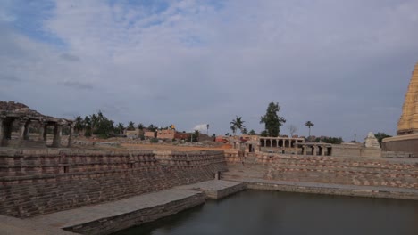 Pan-view-of-Virupaksha-Temple-Gopuram-or-gopura-or-monumental-entrance-tower-with-Pond-at-Hampi
