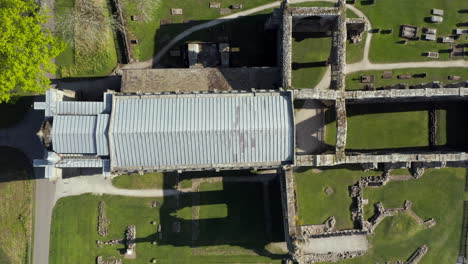 Aerial-Birds-Eye-Shot-of-Bolton-Abbey-from-West-to-East-revealing-entire-Building-and-Graveyard-on-Sunny-Summer’s-Morning