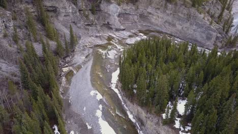 Static-aerial-view-of-a-boreal-river-canyon-in-spring