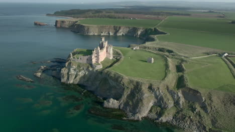 An-aerial-view-of-the-side-and-front-of-Tantallon-Castle-ruin-on-a-sunny-day,-East-Lothian,-Scotland