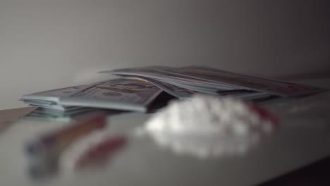 Dramatic-police-lights-flashing-rack-focus-on-isolated-drugs-and-money-scene