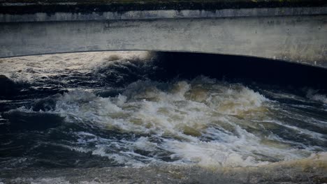 Close-up-view-of-water-in-Corrib-river-churning-and-rushing-toward-the-sea-in-Galway,-Ireland