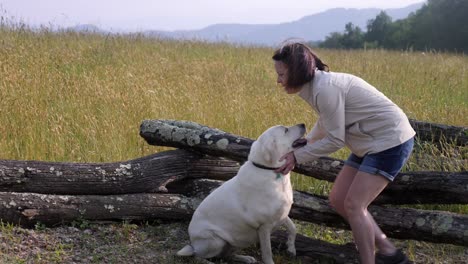 Woman-and-White-Lab-outdoors-with-mountain-backdrop