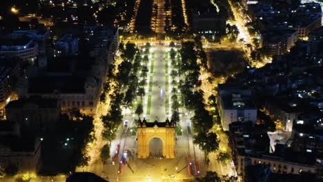 Barcelona-Aerial-view-of-Triumph-Arch,-at-night-with-street-lights,-Spain