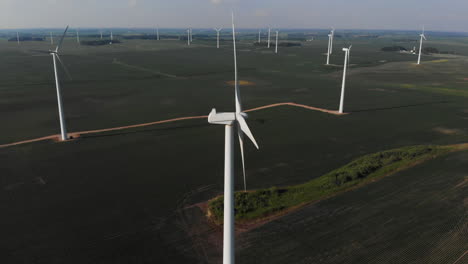 Drone-orbiting-around-a-windmill-turbine-in-a-green-field-of-beans-in-the-midwest
