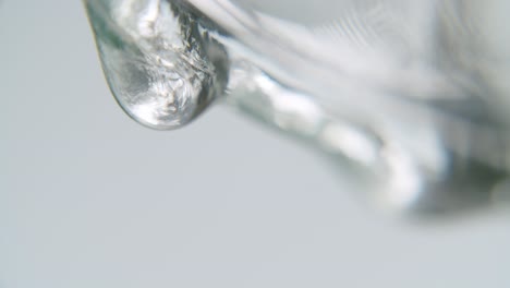 White-transparent-fluid-forming-slowly-a-drop
