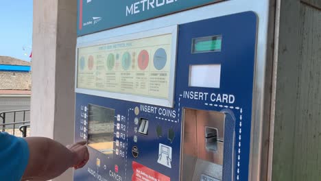 An-Asian-senior-explaining-how-to-purchase-a-Metrolink-ticket-from-the-self-serve-electronic-kiosk