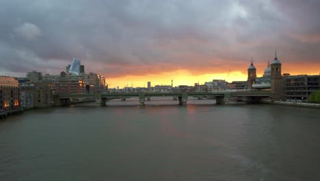 View-down-the-river-Thames-from-London-Bridge-showing-Blackfriars-railway-station-and-Blackfriars-bridge-during-a-moody-sunset