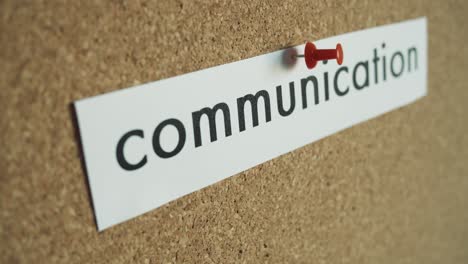 Sticky-note:-COMMUNICATION---Pinned-to-cork-wall---and-removed