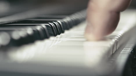 Macro-shot-of-a-musician's-hands-while-he-plays-keyboards