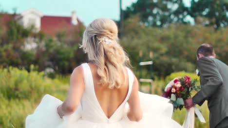 Bride-running-through-field-in-slow-motion