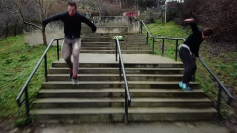 Stabilized-Tracking-Shot-of-Two-Parkour-Free-Runners-Flipping-Down-Flights-of-Stairs