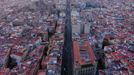 Barcelona-Aerial-view-of-Via-Laietana-at-sunset-and-mountains-in-the-background,-Spain