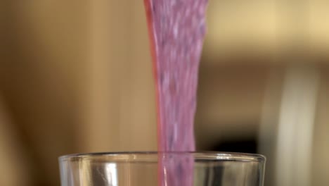 Smoothie-being-poured-into-glass-in-slow-motion